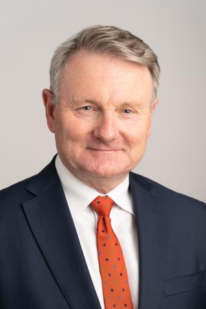 Image of Gerard Fogarty, a man wearing a suit and tie smiling